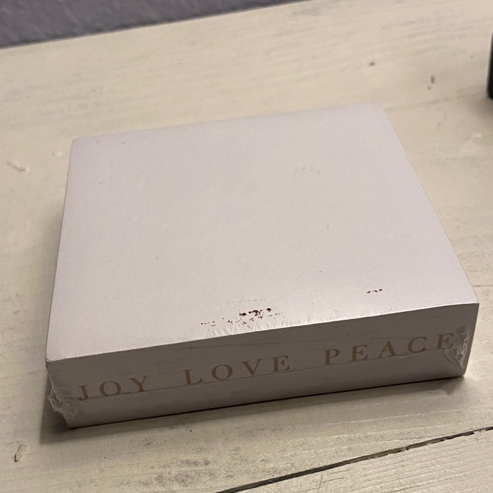 White writing Block with Joy Love Peace Text